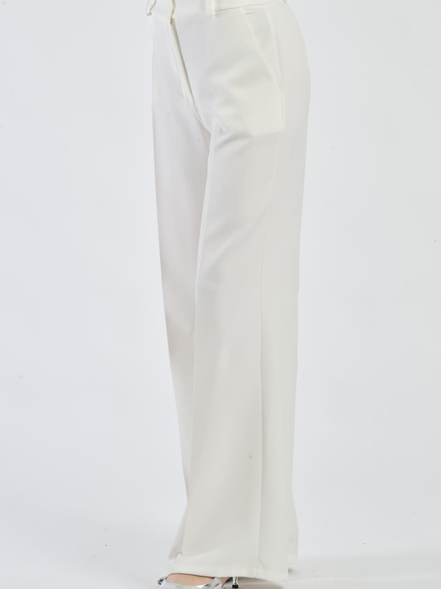 Pantaloni bianchi fluidi con chiusura a bottoni, freschi e confortevoli.