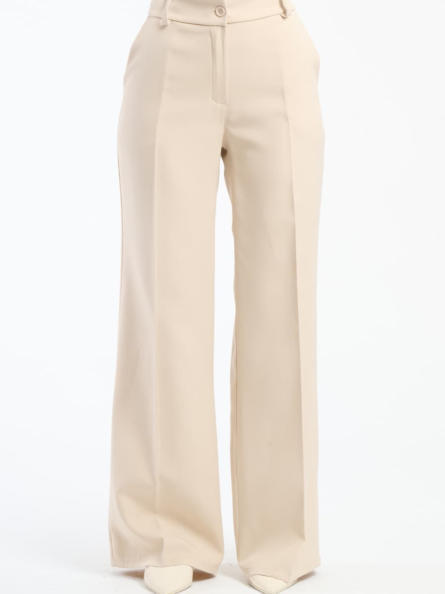 Pantaloni larghi beige con pieghe frontali, tonalità neutra e versatile.