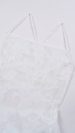 Abito corto elegante a spalline sottili con scollo a fascia, tessuto jacquard floreale e dettaglio a croce sul retro