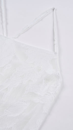 Abito corto elegante a spalline sottili con scollo a fascia, tessuto jacquard floreale e dettaglio a croce sul retro