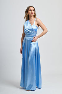 Abito azzurro in tessuto satinato, spalliera singola e drappeggiato sul busto.