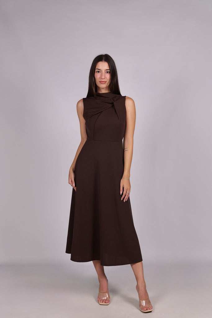 Abito marrone da donna, senza maniche, lunghezza midi, dettaglio nodo sul petto, stile elegante e terra.
