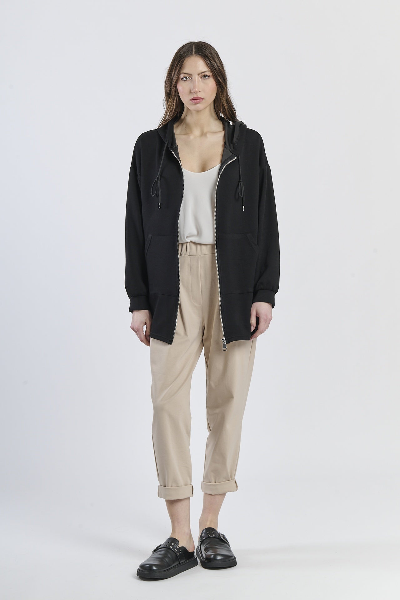 Felpa oversize nera, cappuccio con lacci, abbigliamento intenso, atmosfera elegante