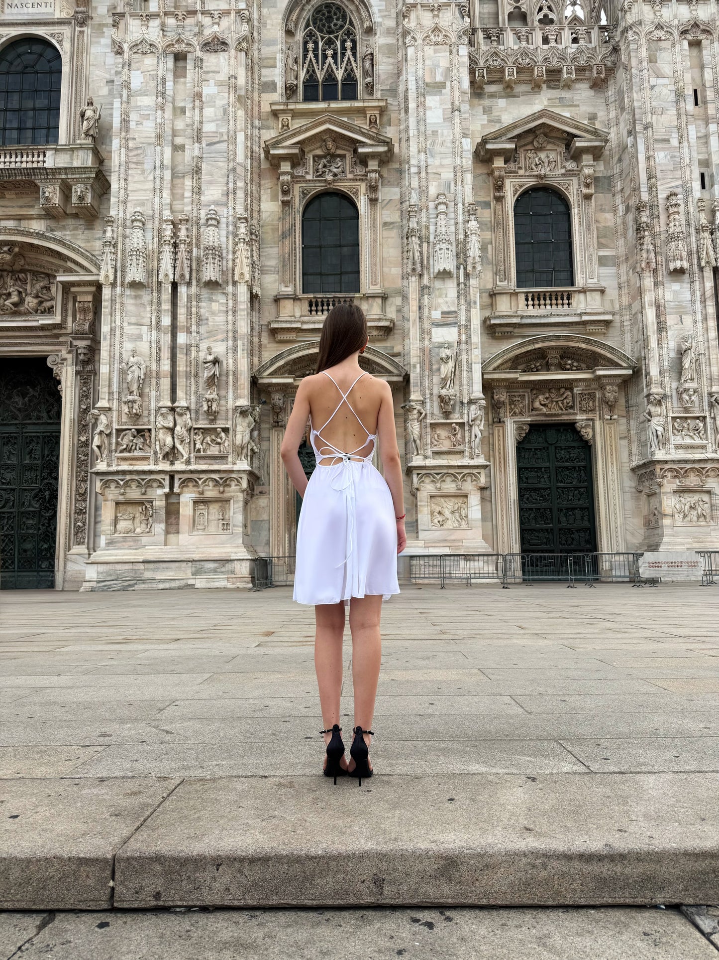 Vestito bianco a spalline sottili e il Duomo di Milano come sfondo