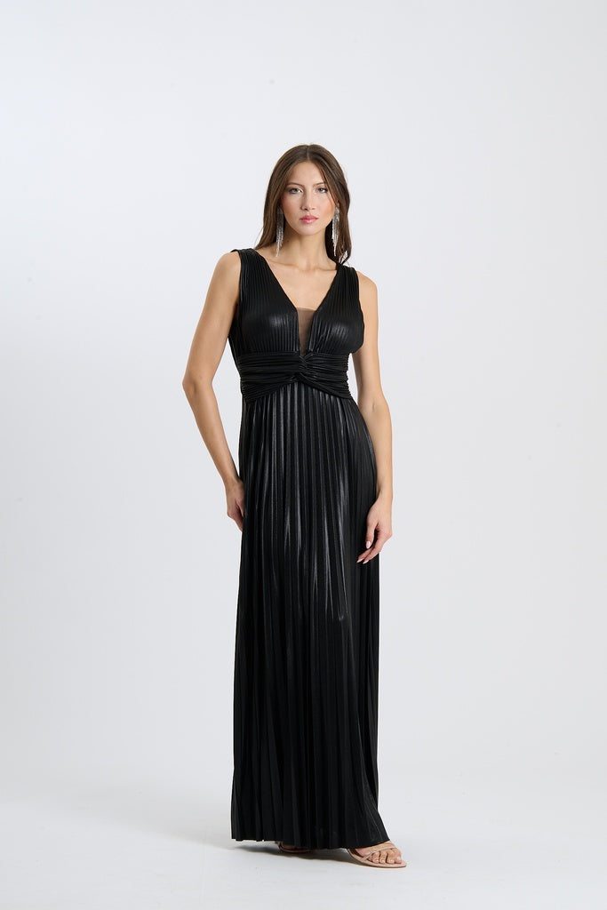 Una donna indossa un abito da sera lungo senza maniche di colore nero con plissé e scollatura a V, su sfondo chiaro.
