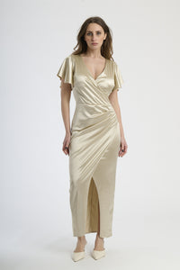 Donna con abito beige in velluto, calore neutro e eleganza rassicurante.