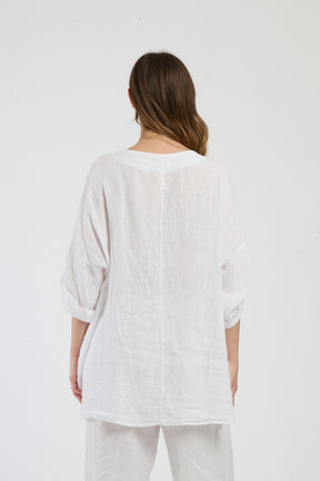 Ensemble bianco, top a maniche corte e pantaloni larghi, serenità per l’estate in città.