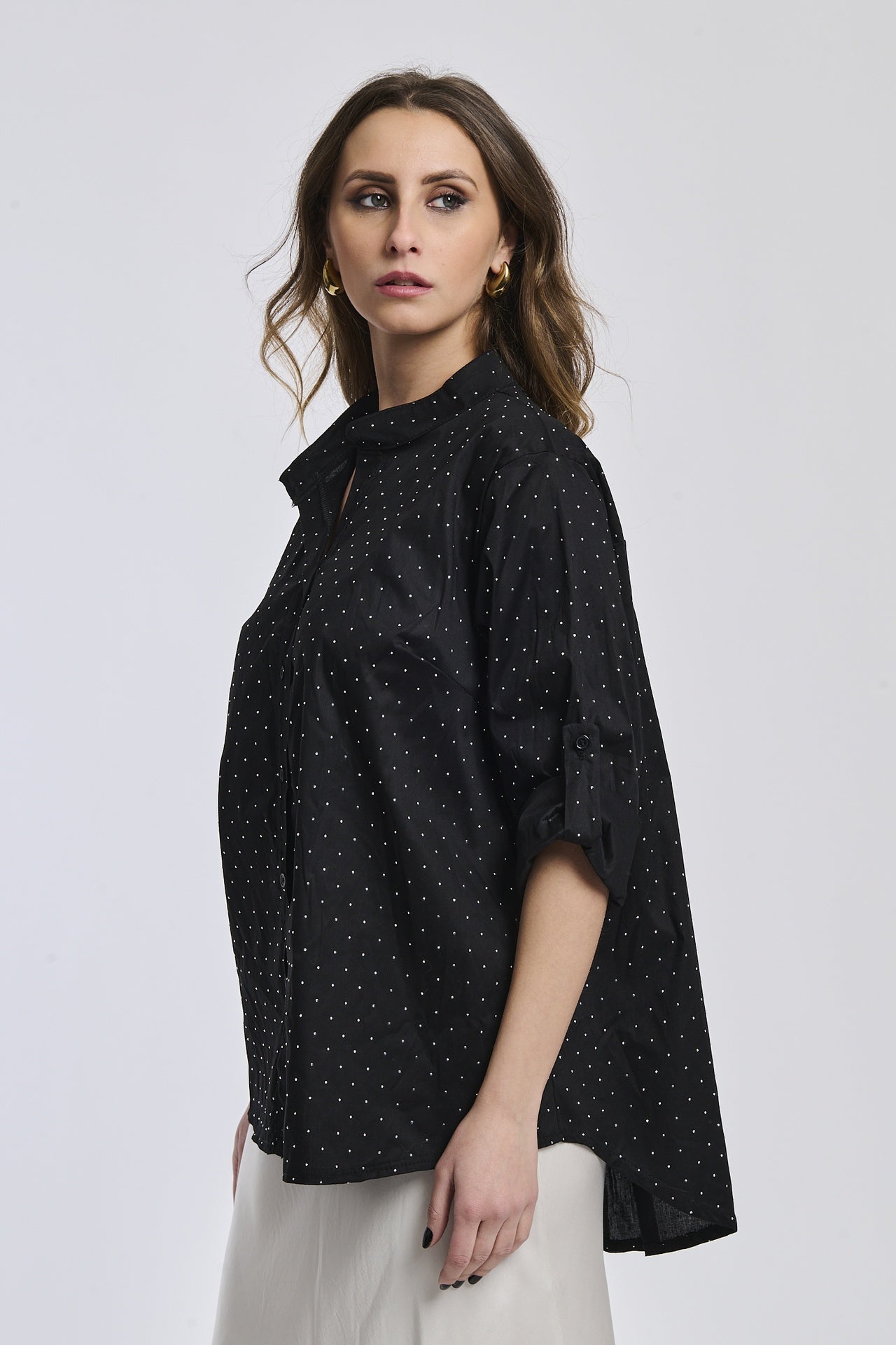 Camicia nera oversize, colletto alto, maniche arrotolate, stile cool e moderno.
