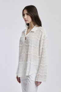 Outfit casual: camicia traslucida bianco e pantaloni bianchi, donna con capelli lunghi e orecchini