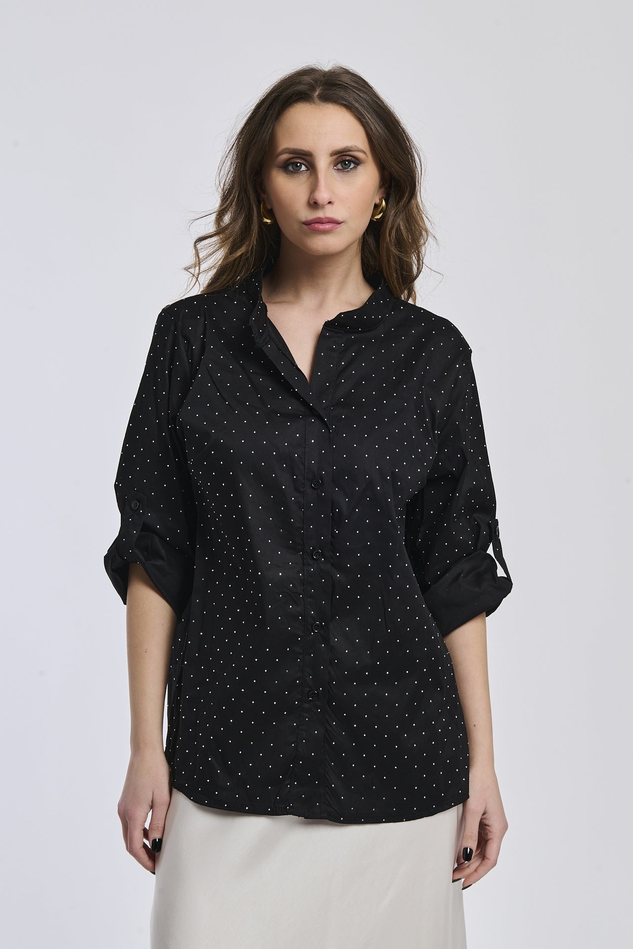 Camicia oversize nera, colletto alto, bottoni frontali e maniche arrotolate, perfetta per un outfit notturno.