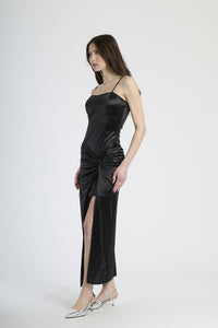 Vestito formale nero, tessuto liscio con accento di stropicciature e apertura